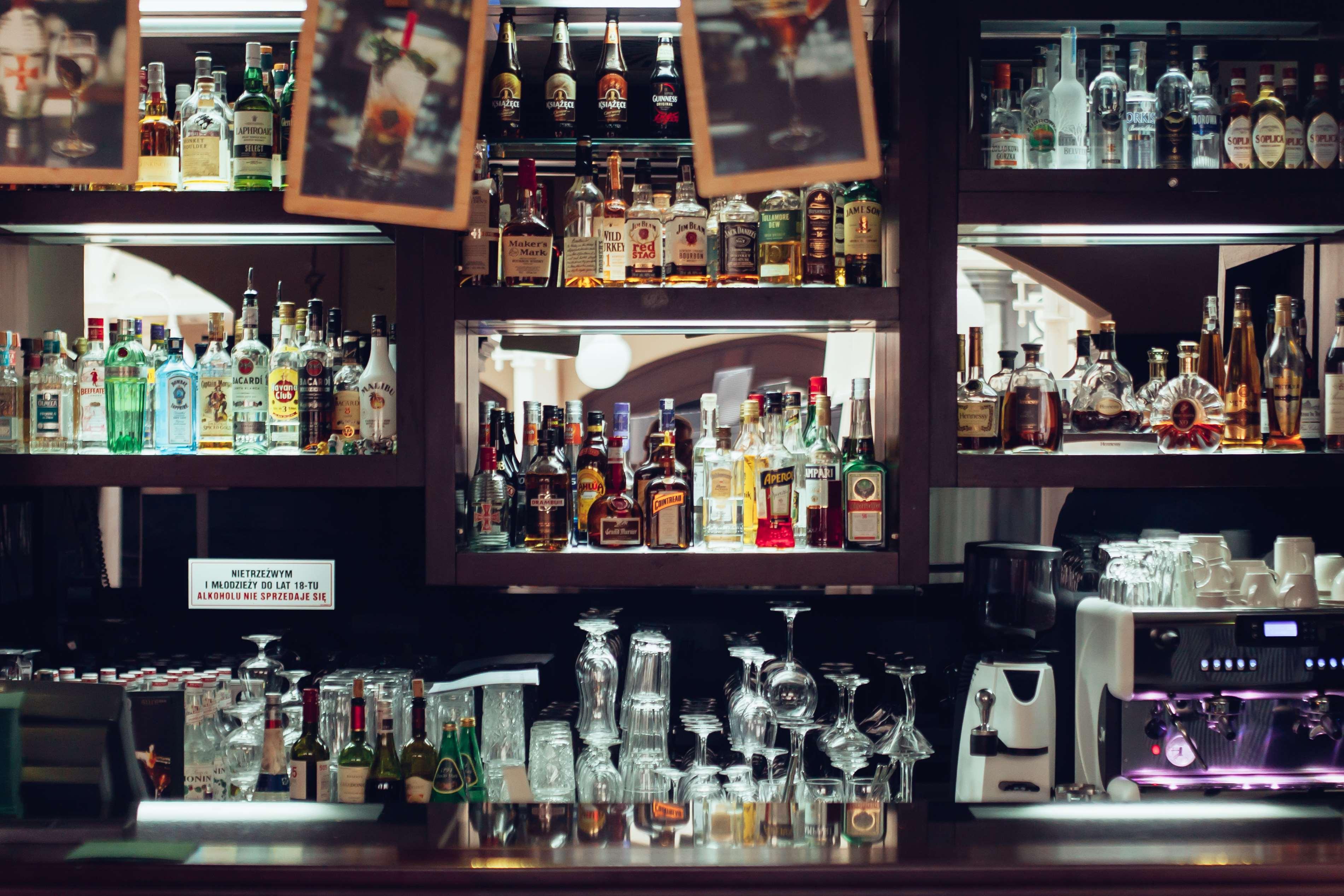 فندق راديسون بلو، غدانسك المظهر الخارجي الصورة The photo depicts a bar area featuring a wide variety of alcoholic beverages neatly arranged on shelves. The shelves are filled with bottles of different sizes and colors, including spirits and liquors. In the foreground, there are several glassware 